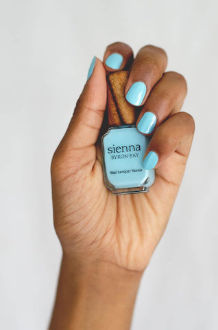 Pastel blue nail polish hand swatch on medium skin tone by sienna