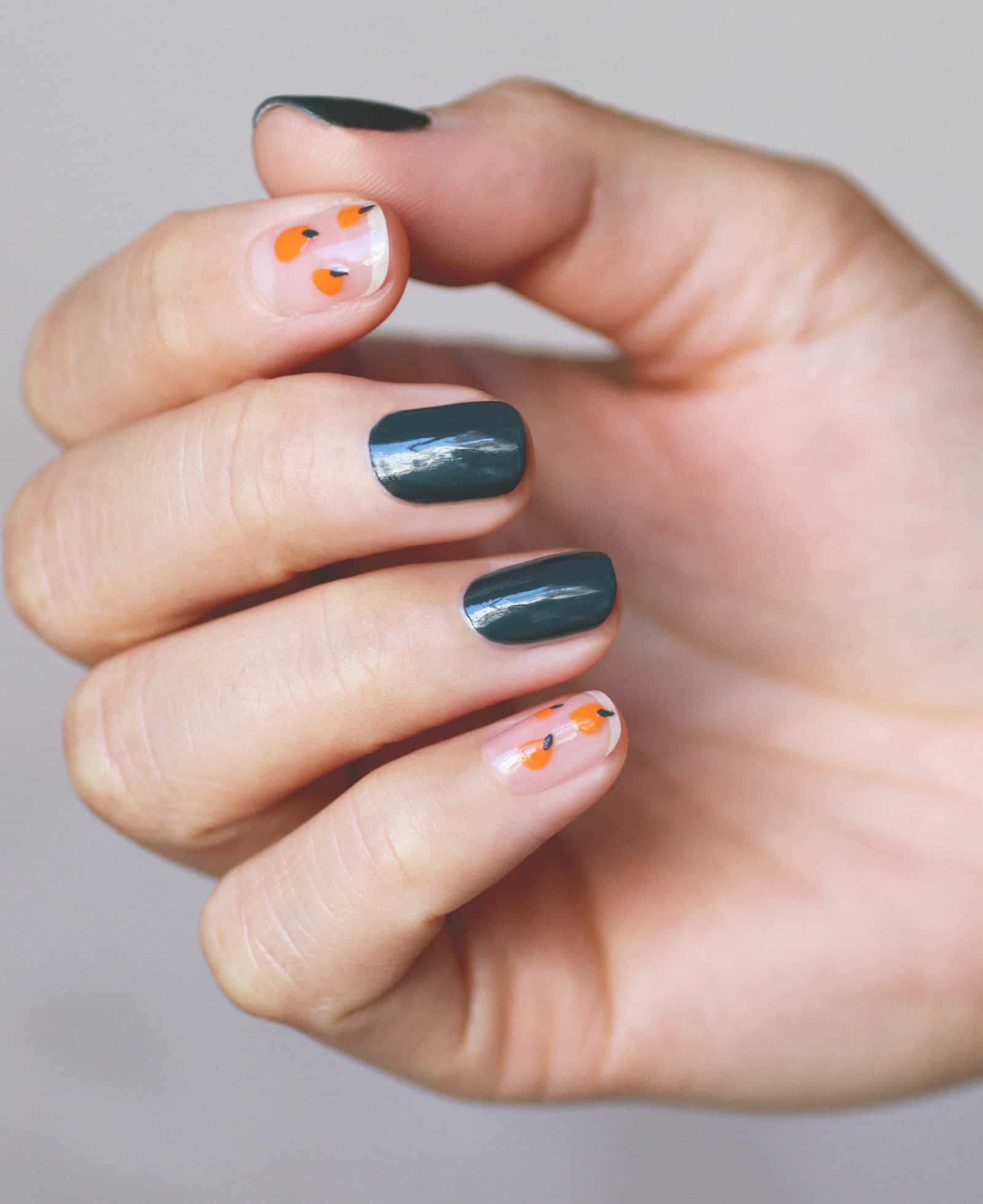 green and orange nail art hand swatch on fair skin tone by line spa and polish and sienna