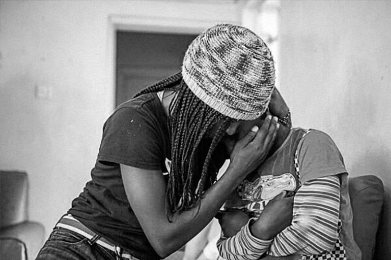 black and white photo of two kenyan teenage girls hugging