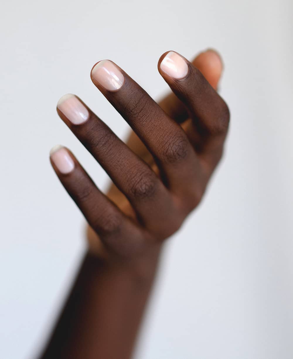 Translucent rosewater pink sheer nail polish hand swatch on dark skin tone by sienna