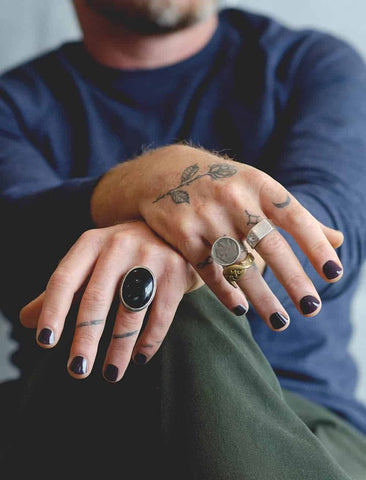 man wearing dark purple nail polish by sienna and wearing rings by pirates dreaming