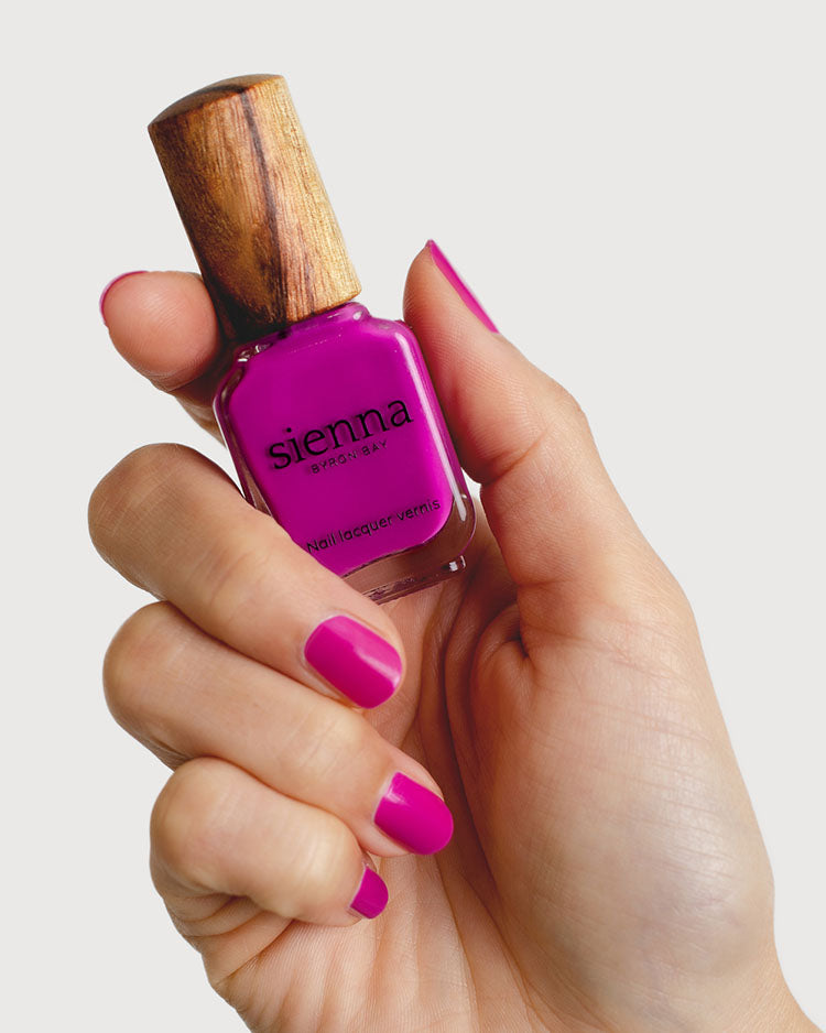 Queen bright magenta Crème non-toxic nail polish on women with fair skin hands