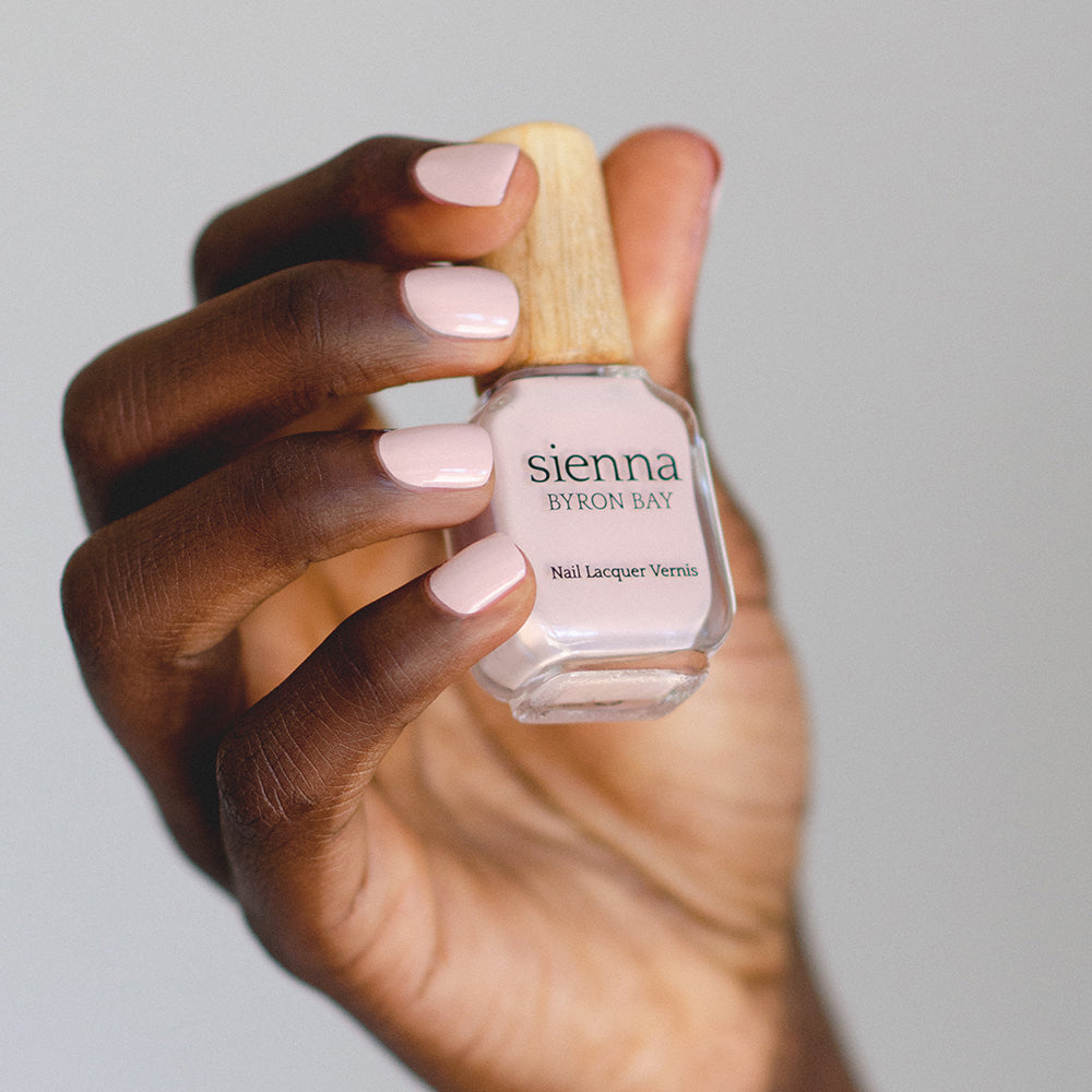 light pink nail polish hand swatch on dark skin tone by sienna