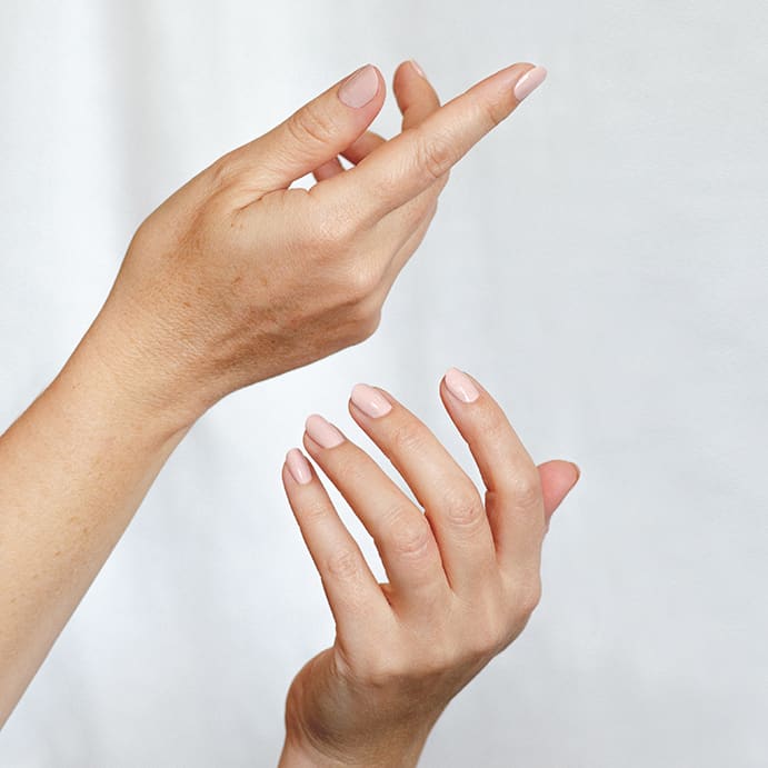 Light pink nude nail polish hand swatch on fair skin tone by sienna