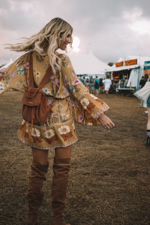 young blond woman spinning around at bluesfest wearing spell and the gypsy dress and high brown boots