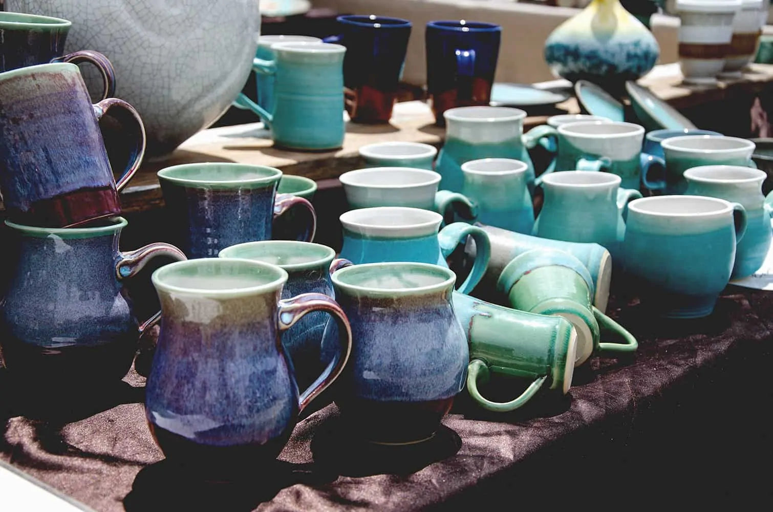 homemade blue and turquoise ceramic cups at byron bay market