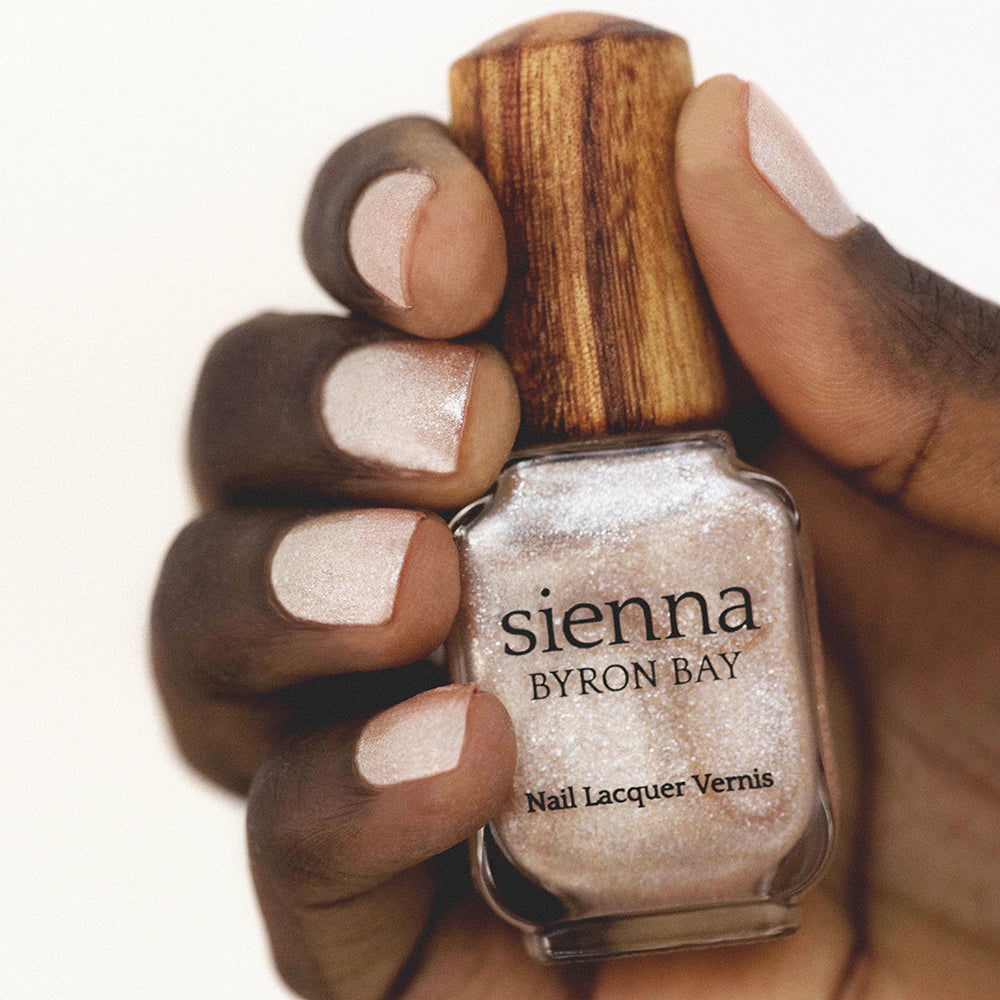 pink crystal nail polish hand swatch on dark skin tone by sienna