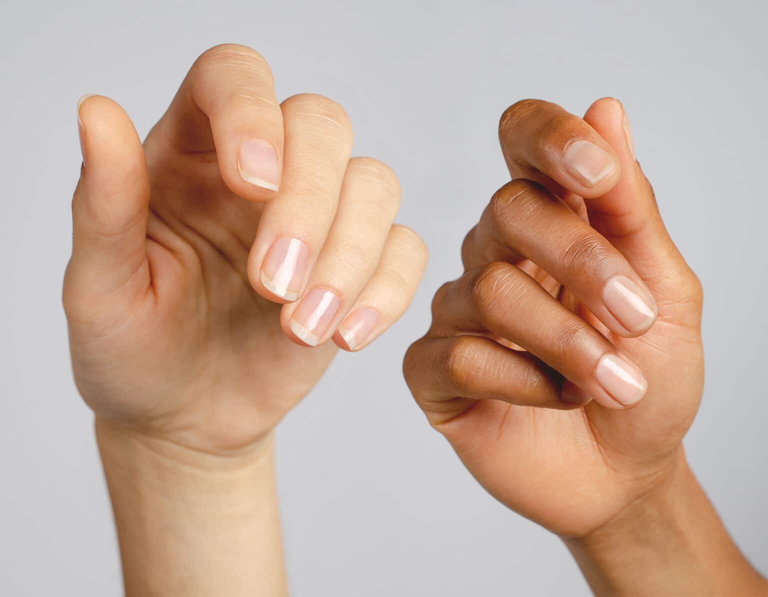 fair and medium skin tone hands wearing clear nail polish by sienna byron bay