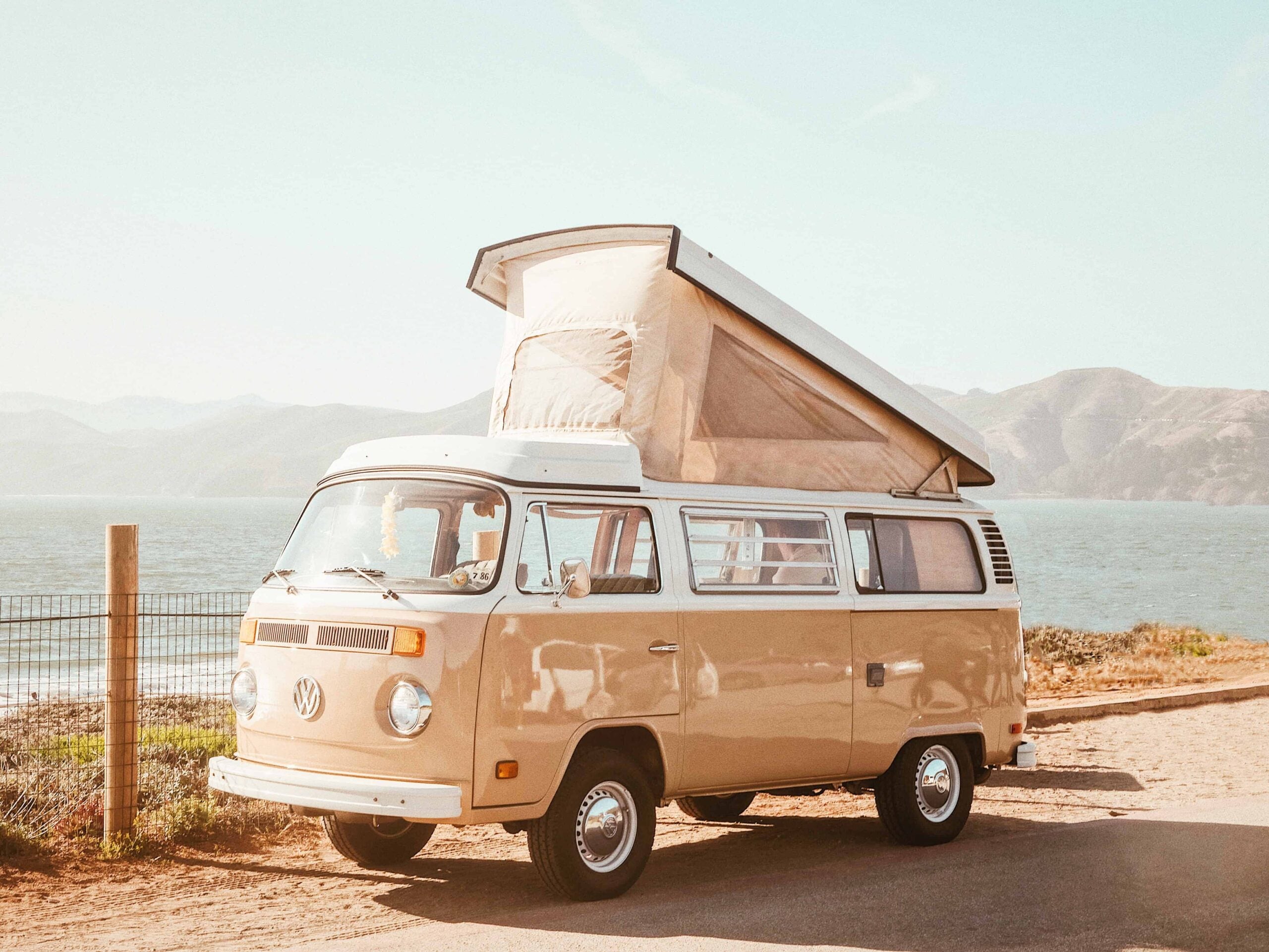 road trip vintage beige volkswagen winnebago in front of the beach in australia