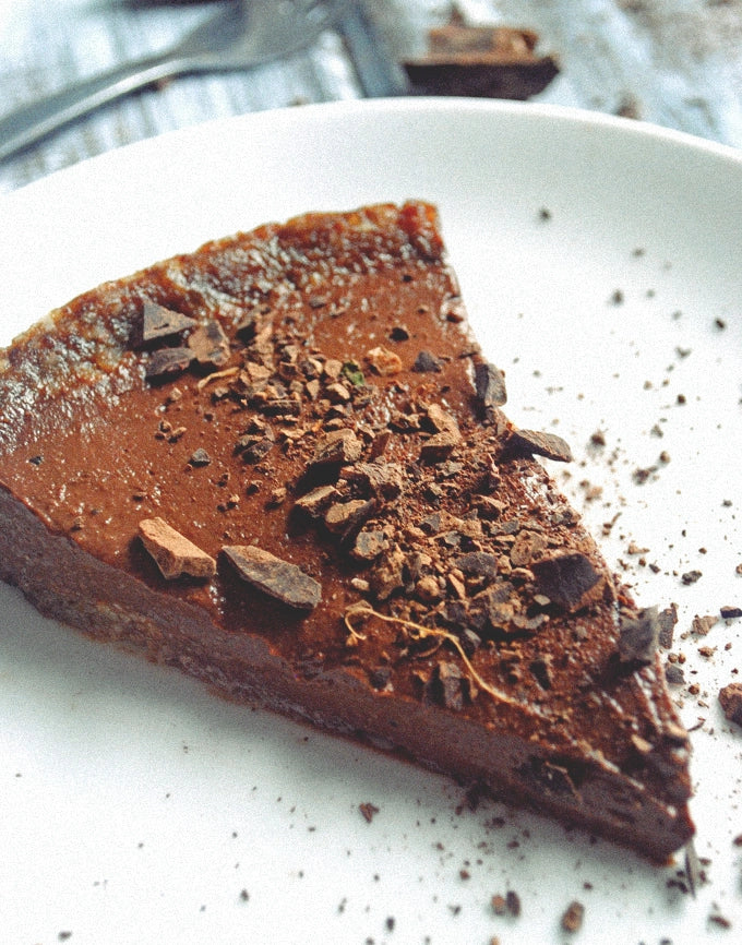 vegan chocolate pudding pie piece in white plate