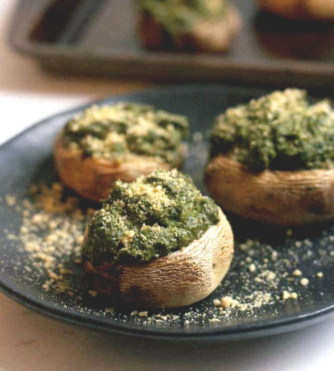 vegan stuffed mushrooms with basil hummus in black plate