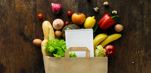 grocery bag with produce and list