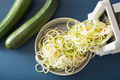Spiralizing courgette raw vegetable with spiralizer stock photo