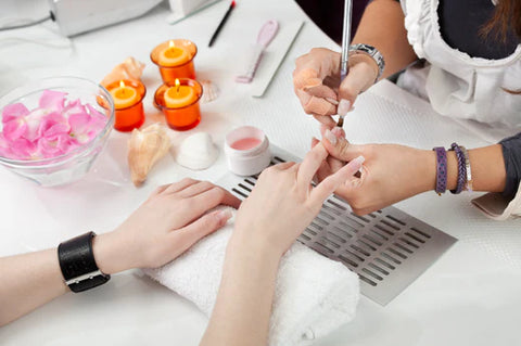 hands being manicured in a salon