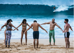 Friends on beach in maui doing yoga