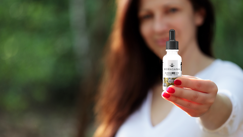 Woman holding CBD tincture