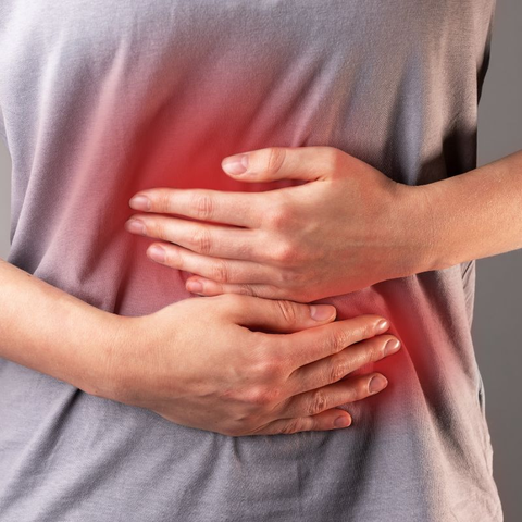 Woman holding her stomach in pain.