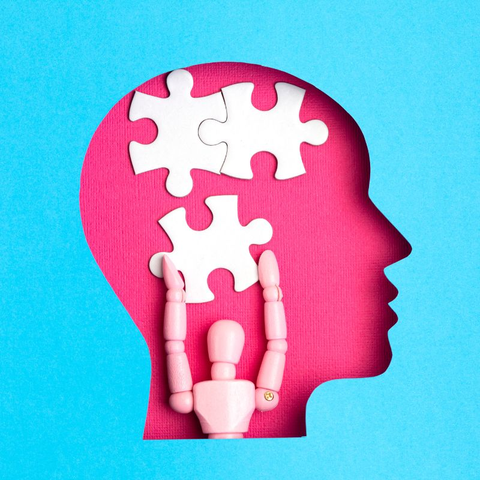 Image of a man's head with a puzzle piece representing cognitive function.