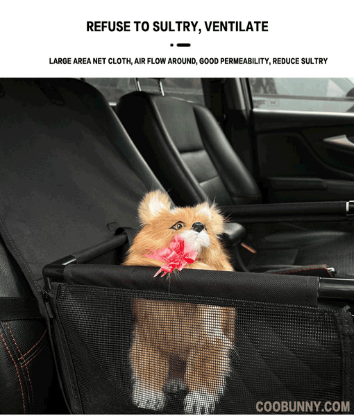 A dog in a black pet car seat