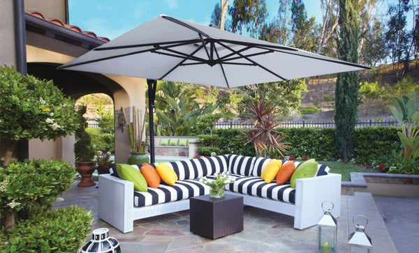A Cantilever positioned over a black and white striped outdoor patio sectional