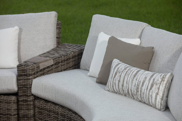 White and brown outdoor furniture cushions resting on a Avallon curved sectional