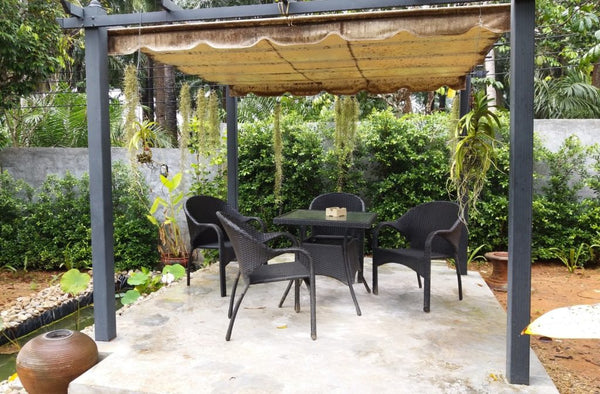 A sunny backyard patio with a canopy covering