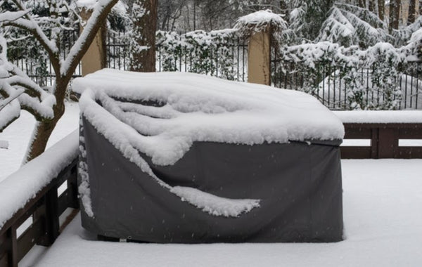Patio furniture that is tarped to protect it against harsh elements