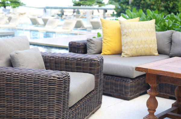 Outdoor patio furniture with grey and yellow cushions