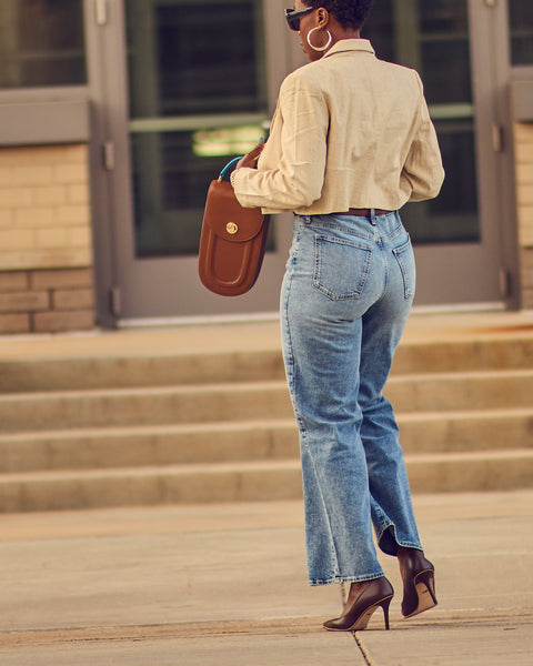 Fashion blogger Farotelle wearing Target wide-leg blue jeans with Banana Republic cropped blazer, Coach Waverly brown pumps, and Tomoli Fitini brown handbag as Spring Summer elevated casual outfit blazer and jeans women style.