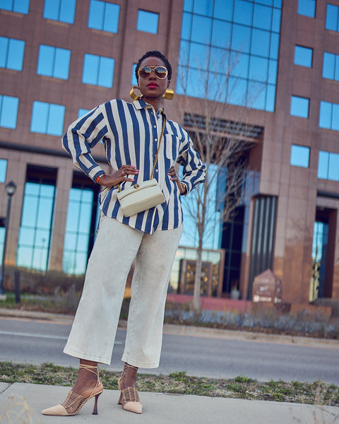 Farotelle wearing light-wash Target cropped jeans with striped boyfriend shirt, Sam Edelman lace-up heels, Kurt Geiger crossbody bag as Elevated Casual Spring Summer Outfit.