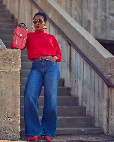 Farotelle wearing Gap blue jeans with Ann Taylor red blouse, oversized hoop earrings, brown leather belt, dressy red pumps, red leather bag as Colorful Elevated Casual Spring Summer Outfit Style.