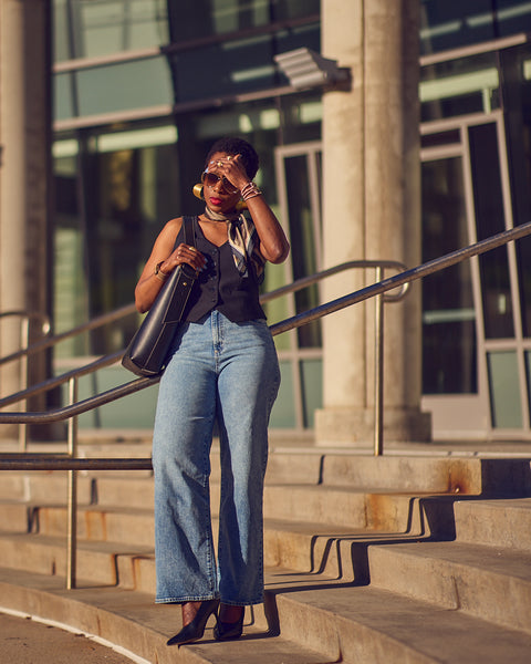 Fashion blogger Farotelle wearing Target wide-leg blue jeans with Express black vest, Sam Edelman black leather pumps and Banana Republic black Vida tote as Spring Summer elevated casual outfit, jeans style, street style.