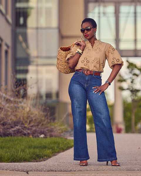 Fashion blogger Farotelle wearing Gap wide-leg blue jeans with Ann Taylor brown eyelet top, Coach shoes, Levi's belt, and Target large straw bag as Spring Summer elevated casual jeans outfit, neutral style, weekend looks.