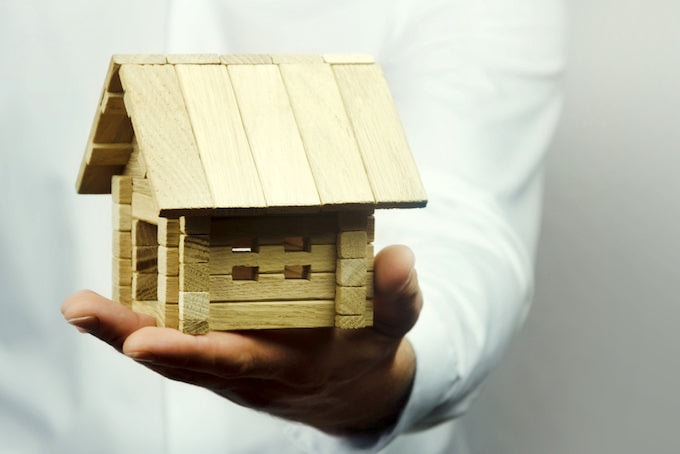Small wooden house on a hand
