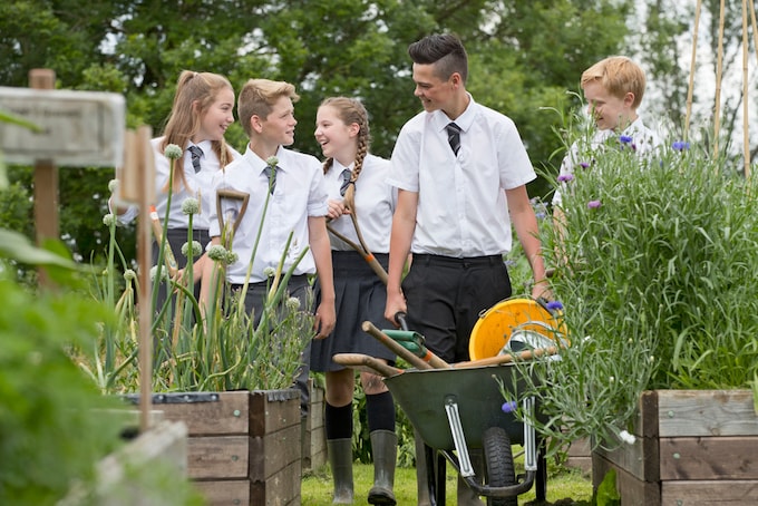 Kids in school uniform illustrating the school gardening club