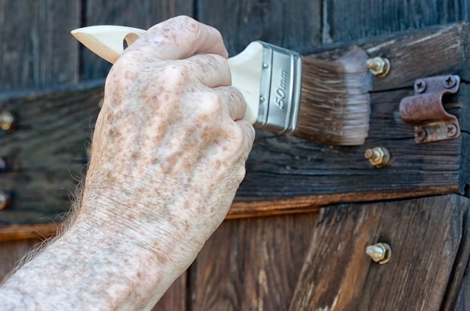 Treating wood with a paintbrush