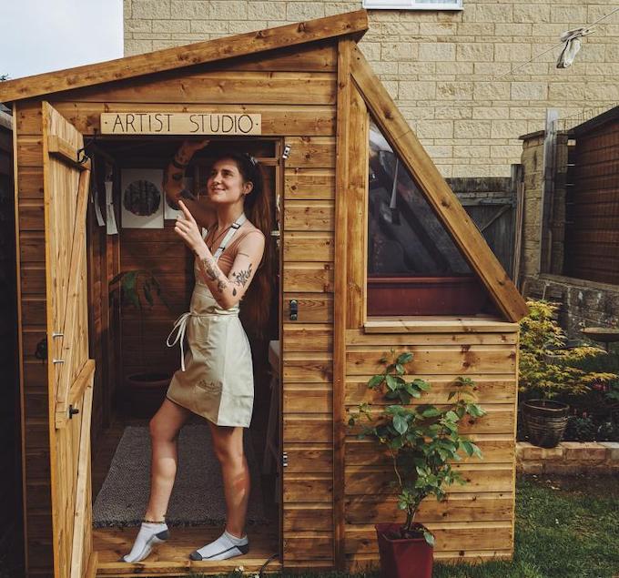 Woman standing in doorway of her potting shed artist studio