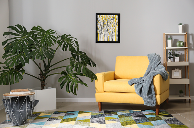 yellow armchair in office with grey blanket