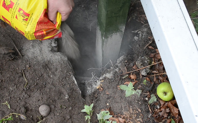filling a fence post hole with postcrete