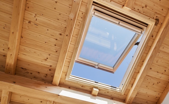 Open roof window vent in wooden house