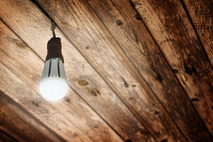 Artificial lighting against wooden ceiling
