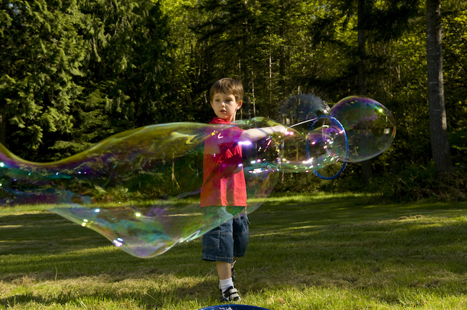 Little boy playing with bubbles