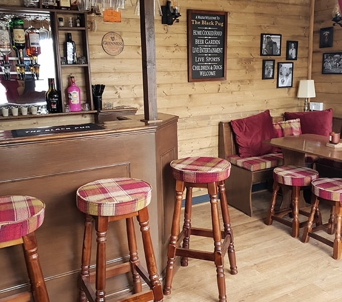 Bar and seating area view in The Black Pug log cabin