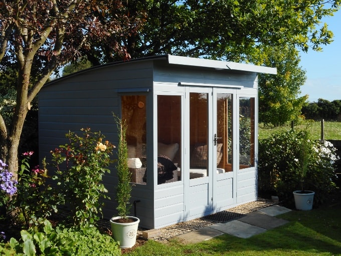 Blue curved wooden Waltons summer house