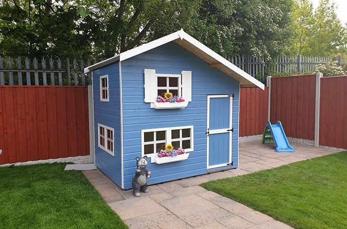 Blue and white playhouse with colourful windowboxes