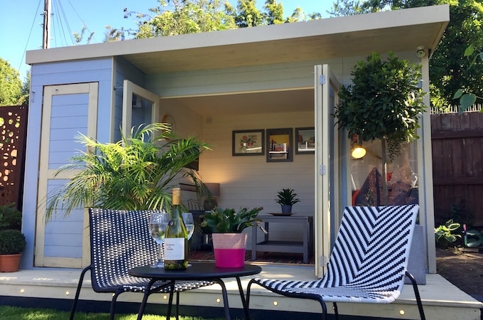 Blue and yellow summerhouse with exterior wine bar