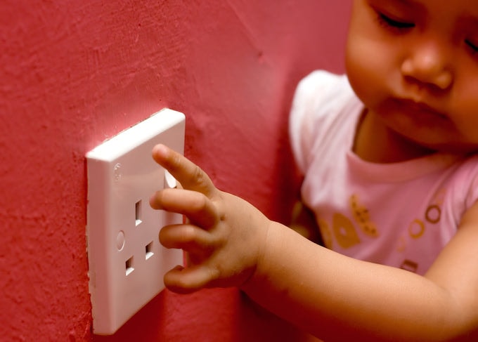 Child touching plug socket