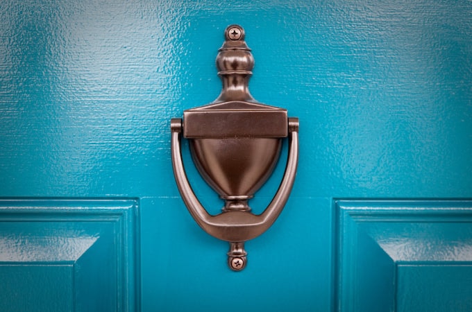 Closeup of blue door with brass knocker