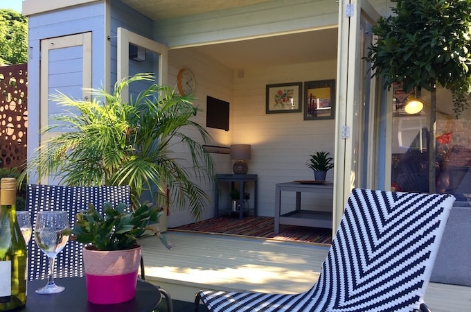 Closeup of painted summerhouse with outdoor seating