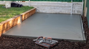 Concrete shed base in a garden
